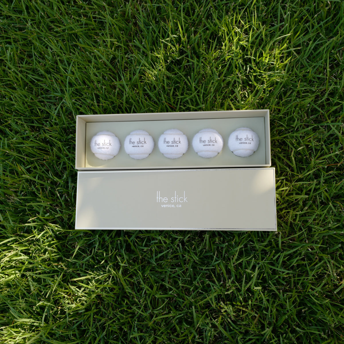 Tennis Ball Boxes gift box on grass